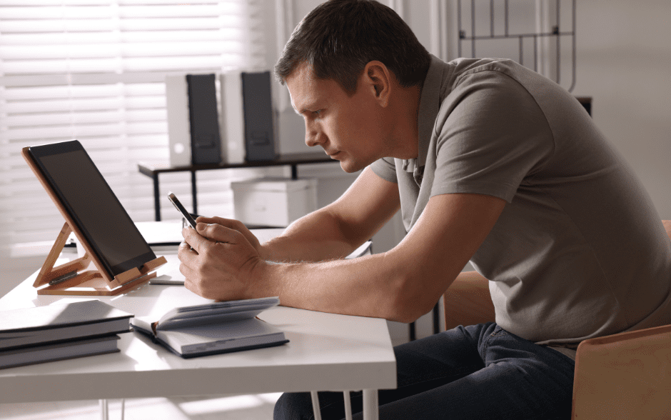 slouching, text neck, man sitting with a phone, bad posture, incorrect posture