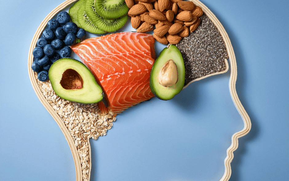 Brain-shaped layout of healthy foods like salmon, avocado, nuts, and berries, highlighting the gut-brain connection.